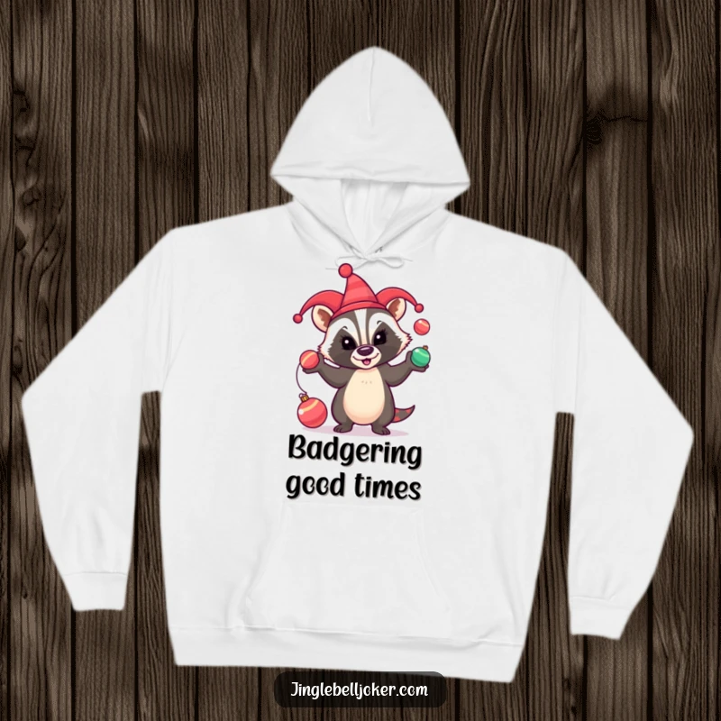 Funny Hoodie: A badger wearing a jester hat comically juggles festive baubles, perfect for holiday humor.