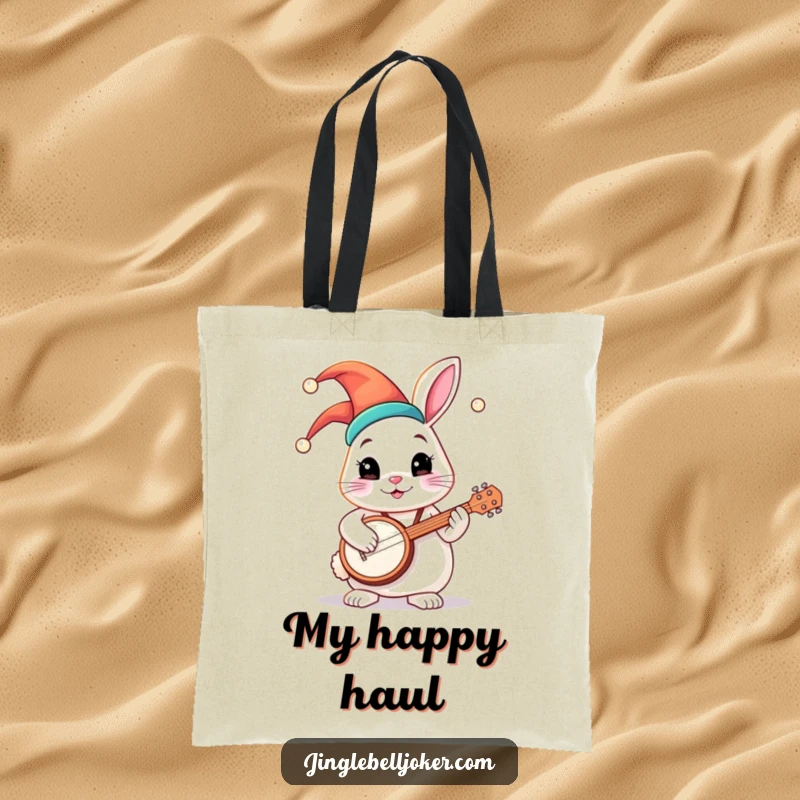 Funny tote bag featuring a round bunny character in a colorful jester hat, happily playing a tiny banjo, great for music lovers.