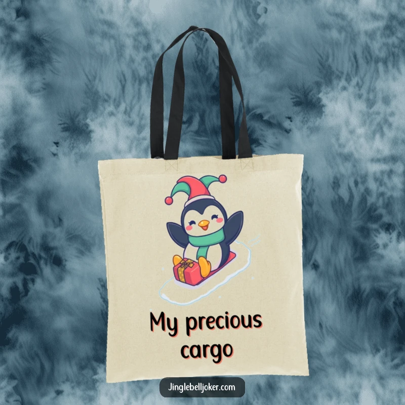 Funny Penguin Jester Tote Bag, featuring a happy penguin in a jester hat sliding down a gift-wrapped slope, a humorous carry-all.